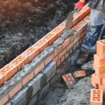 Crafting,A,Sturdy,Foundation,With,Orange,Bricks,During,Construction,On