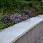 Concrete,Retaining,Wall,With,Stone,Collar,Builds,On,Purple,Flowers