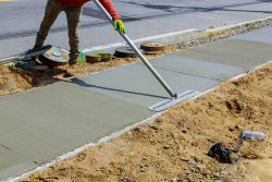 Laying,Down,New,Sidewalk,In,Wet,Concrete,On,Freshly,Poured