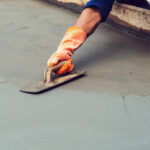 Worker,Leveling,Concrete,Pavement,For,Mix,Cement,At,Construction,Site