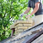 Bricklayer,Repair,Brick,Chimney,On,Asbestos,House,Rooftop