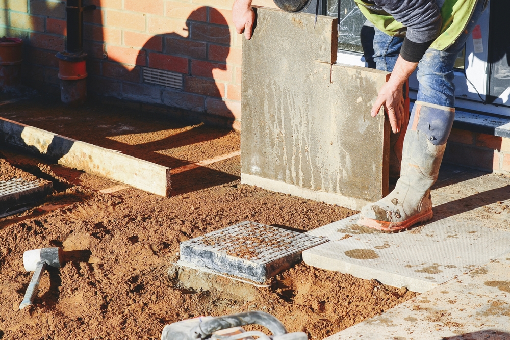 Builder,Lays,Concrete,Paving,Slabs,For,Outdoor,Patio,Construction,At