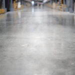 Low,Angle,View,Of,Concrete,Floor,In,Large,Warehouse,Store.