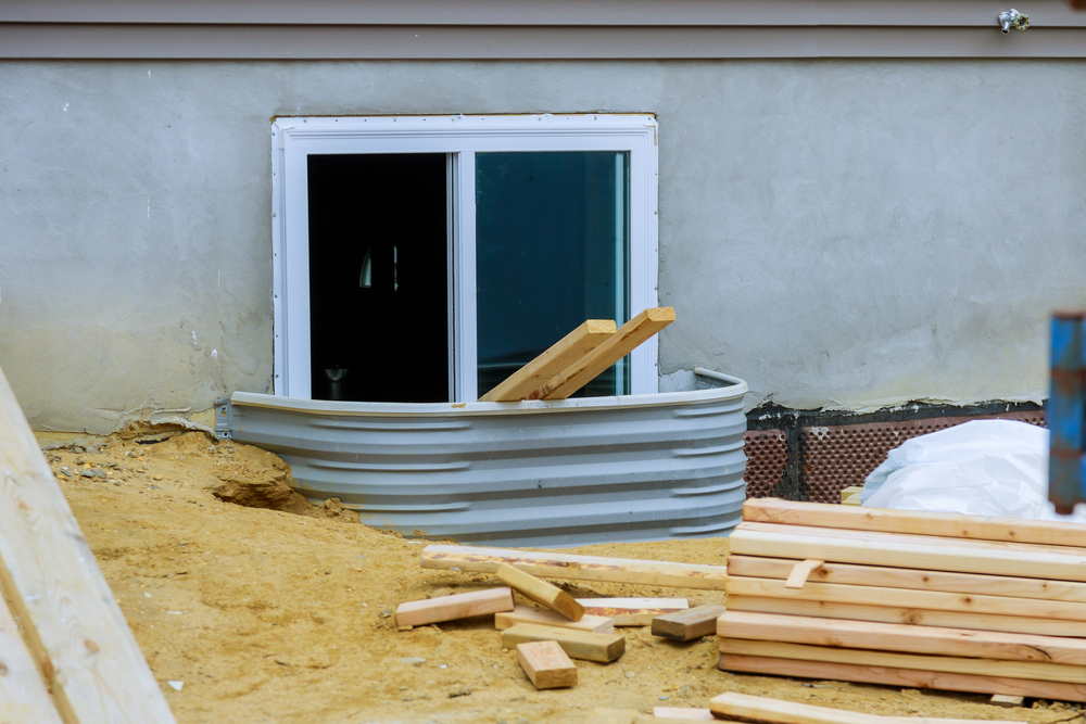 Stack,Of,Unloading,Wooden,Beams,On,Window,Well,On,Basement